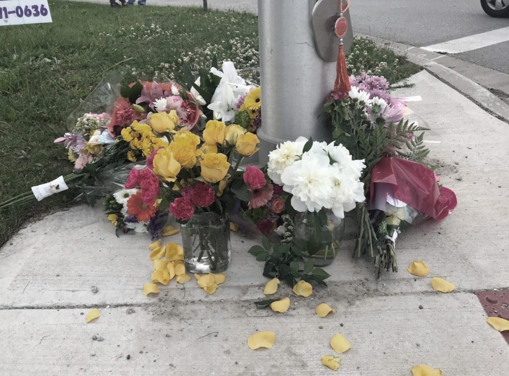 flowers around a vigil for the london family